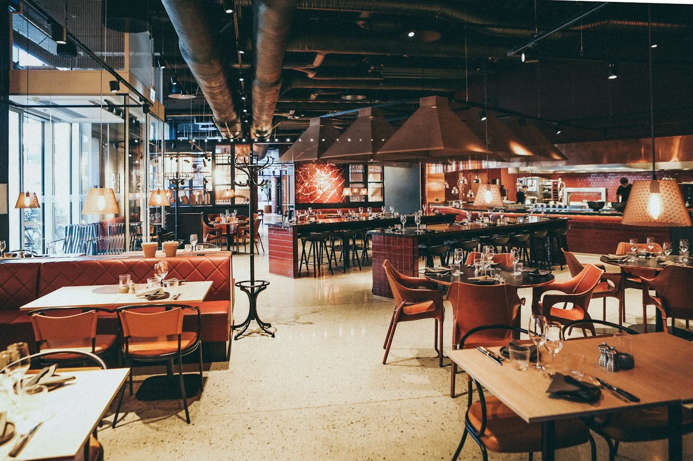 Sunlit tables and warm wood in a restaurant dining room